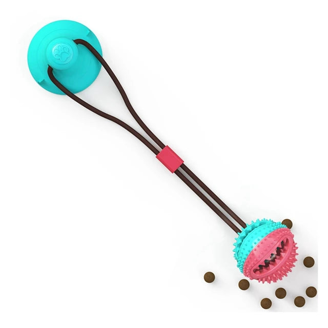 Suction cup interactive dog toy stuck to the floor with a ball attachment